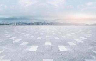 Empty brick floor square floors with panoramic views of the city skyline and buildings photo