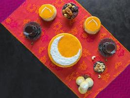 Delicious homemade golden cake with a Crescent moon, served with black coffee and dates. Ramadan background, copy space photo