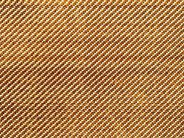Bulletproof material aramid. Aramid kevlar background. Golden kevlar texture and pattern. photo
