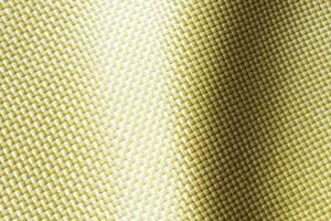 a prueba de balas material aramida aramida kevlar antecedentes. dorado kevlar textura y modelo. foto