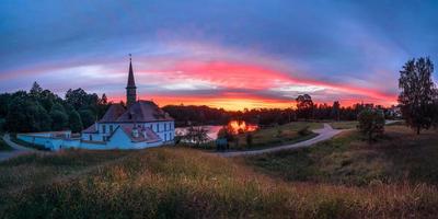 Wonderful evening sunny landscape. Incredible majestic Priory Palace in Gatchina. Amazing natural background photo