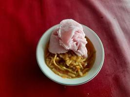 a rujak or spicy fruit salad dish topped with strawberry ice cream photo