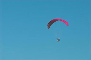 paragliders in the blue cloudless sky photo