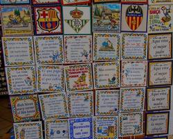 ceramic tiles souvenirs in a shop in the south of spain in a tourist town, colorful art crafts background photo