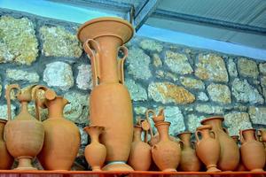 handmade clay dishes in the Greek style in the shop at the potter's workshop photo