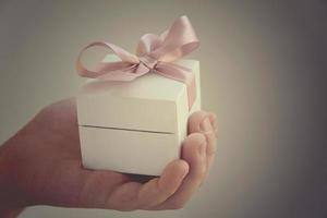 a gift in a white box with a pink bow photo