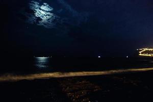 night view of the turkish city of alanya with lights on the hill photo