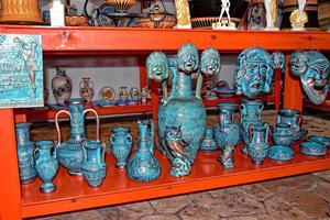 handmade clay dishes in the Greek style in the shop at the potter's workshop photo