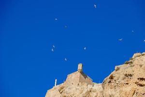 castle of saint barbara in alicante spain against blue sky landmark photo