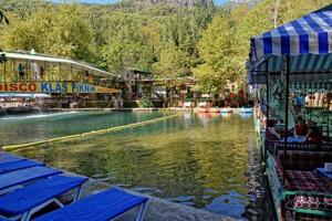 calm summer landscape on the turkish river Dim with restaurant on the water photo