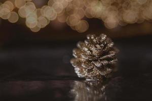 golden christmas cone on the background of bokeh in closeup photo