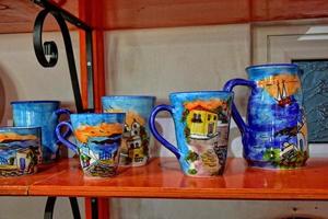 handmade clay dishes in the Greek style in the shop at the potter's workshop photo