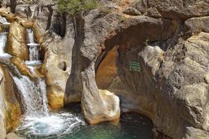 a natural wild landscape in the Turkish mountains with an interesting waterfall and the sapadere canyon photo