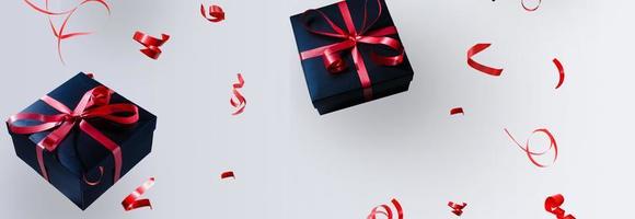 Black gift box with red satin ribbon and bow, over white background. photo