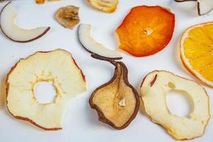 Dried fruits isolated on white background. Healthy eating concept. Top view. Healthy vegetarian food concept. Dried fruit chips. photo