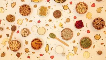 Healthy vegetarian food concept. Assortment of dried fruits, nuts and seeds on white background. Top view. video