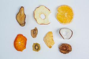 Dried fruits isolated on white background. Healthy eating concept. Top view. Healthy vegetarian food concept. Dried fruit chips. photo