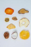 Dried fruits isolated on white background. Healthy eating concept. Top view. Healthy vegetarian food concept. Dried fruit chips. photo