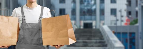 Young man delivering food to customer at doorway photo