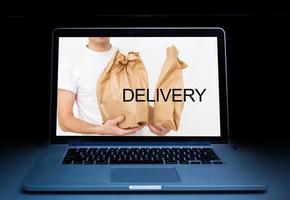 ordering take away food by internet with a laptop, food delivery photo