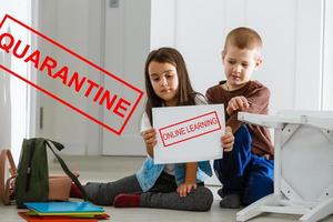 two children are sitting in a room, red inscription quarantine, concept of quarantine measures during the period of the disease epidemic photo