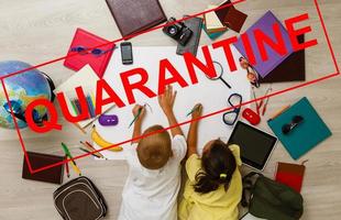 two children are sitting in a room, red inscription quarantine, concept of quarantine measures during the period of the disease epidemic photo