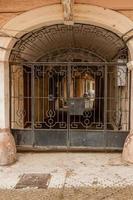 An old gate with a corridor leading to the courtyard of the house photo