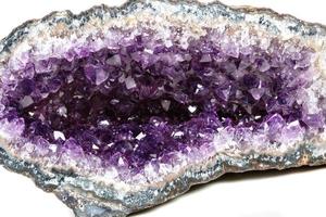 Macro Mineral Stone Amethysts in the rock on a white background photo