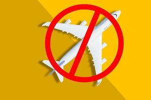 The sign of the ban and a miniature toy aircraft. Ban on flights of civil aircraft. Forbidden zone. Stop symbol. Bans on airport construction. Plane. Night flights. Law. Prohibition photo