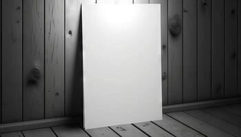 Blank white paper poster on plank wooden floor and wall. photo