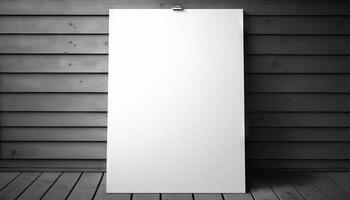 Blank white paper poster on plank wooden floor and wall. photo