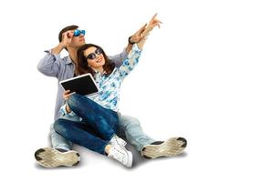 young happy couple using digital tablet, isolated on white photo