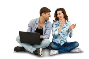 couple sitting with laptop. Hugging and smiling isolated on white background photo