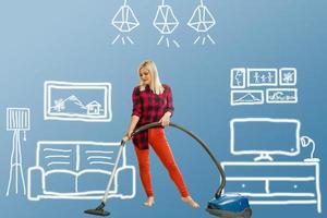 woman vacuuming over drawn home plan photo