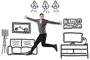 man jumping over drawn home plan photo