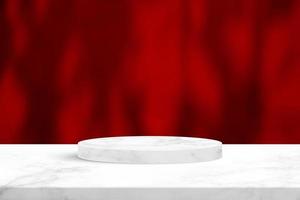 Minimal Marble Cylinder Podium on the Table with Leaf Shadow on White Red Concrete Wall Texture for Background, Suitable for Premium Product Presentation Backdrop, Display, and Mock up. photo