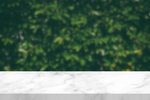 White Marble Table with Blurred Green Garden Background, Suitable for Product Presentation Backdrop, Display, and Mock up. photo