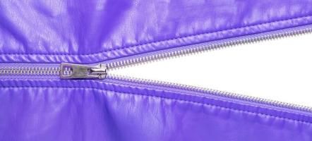 Purple leather texture and open metal zipper isolated on white background photo