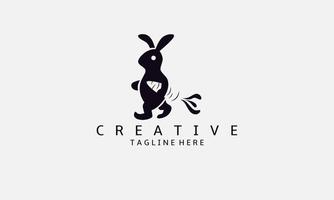 Rabbit logo design template. Vector logo design of a bunny carrying a carrot. Rabbit logo carrying a carrot.