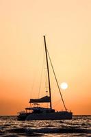 Sailing yacht at sunset photo