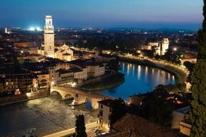 Verona, Italy - panorama by night. Illuminated cityscape with scenic bridge. photo