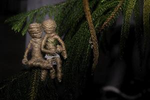 dolls from the ropes were together on the fir tree. romantic photography concept. photo