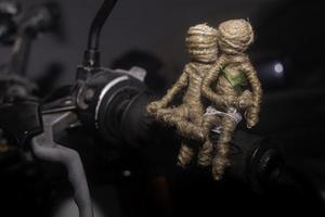 Dolls couple sitting in handlebar of motorcycle. romantic background photography concept. photo