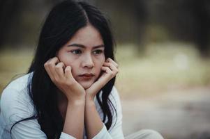 Beautiful thai woman very sad from unrequited love,She rethink and think over about love,vintage style,dark tone,broken heart,asian girl photo
