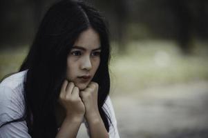 Beautiful thai woman very sad from unrequited love,She rethink and think over about love,vintage style,dark tone,broken heart,asian girl photo