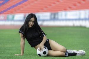Young beautiful asian woman wear soccer player cheer sport,Female fans football cheering game photo