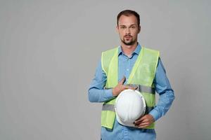 man in white helmet blueprints builder light background photo