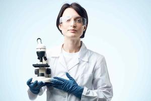 female doctor with microscope in hands technology research science photo