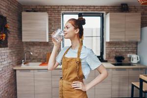 a housewife drinking water kitchen apartment kitchen utensils interior modern style photo