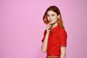 red-haired woman in red dress fashion elegant style pink background photo